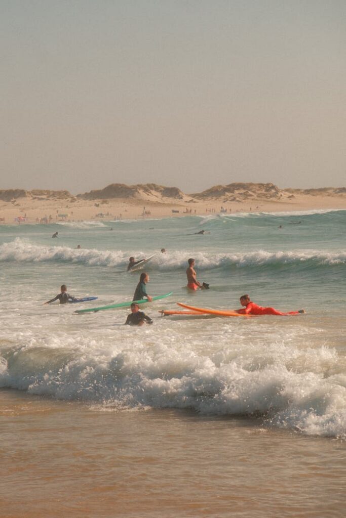 A vibrant scene of surfers and waves enjoying a sunny beach day.